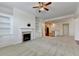 Inviting living room with a fireplace, built-in shelving, and open layout to the kitchen at 3411 Lindenridge Dr, Buford, GA 30519