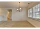 Open living space featuring neutral carpet, white trim, and a view to the bath at 3411 Lindenridge Dr, Buford, GA 30519