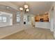 Spacious living space open to the kitchen, features a fireplace, neutral carpet and white trim at 3411 Lindenridge Dr, Buford, GA 30519