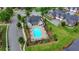 Aerial view of a community pool featuring lounge chairs, tables, manicured landscaping, and ample seating at 3411 Lindenridge Dr, Buford, GA 30519
