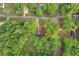 Aerial view shows a home surrounded by trees, highlighting its location on a quiet street at 607 Hickory Creek Ln, Woodstock, GA 30188