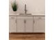 Modern bar area featuring white cabinetry, marble countertops, and a stainless steel sink at 607 Hickory Creek Ln, Woodstock, GA 30188