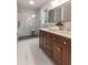 Stylish bathroom with double vanity, marble floors, and glass-enclosed shower with gray tile at 607 Hickory Creek Ln, Woodstock, GA 30188