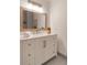 Elegant bathroom featuring a vanity with storage and a large framed mirror, neutral colors and textures at 607 Hickory Creek Ln, Woodstock, GA 30188