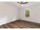 Inviting bedroom featuring hardwood floors, a ceiling fan, and a window overlooking trees at 607 Hickory Creek Ln, Woodstock, GA 30188