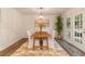 Inviting dining room with wood table, bright natural light, and stylish decor, perfect for gatherings at 607 Hickory Creek Ln, Woodstock, GA 30188