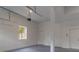 Spacious two-car garage with white walls, concrete floor and a window for natural light at 607 Hickory Creek Ln, Woodstock, GA 30188