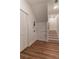 Hallway with wood-look flooring, white walls, closet, and stairs leading to the next level at 607 Hickory Creek Ln, Woodstock, GA 30188