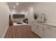 Bright living room with modern bar area, recessed lighting, and wood look flooring at 607 Hickory Creek Ln, Woodstock, GA 30188