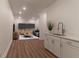 Bright living room with modern bar area, recessed lighting, and wood look flooring at 607 Hickory Creek Ln, Woodstock, GA 30188