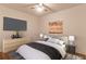 Stylishly staged main bedroom with a ceiling fan, a bed, and modern furnishings at 607 Hickory Creek Ln, Woodstock, GA 30188