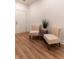 The elegant seating area features stylish chairs and a table set on the warm wood-look flooring at 607 Hickory Creek Ln, Woodstock, GA 30188