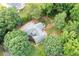 An aerial view of a charming home with brick patio nestled amongst mature trees at 1104 Fox Ln, Woodstock, GA 30188