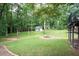Lush backyard with a fire pit, outbuilding and ample space for outdoor activities at 1104 Fox Ln, Woodstock, GA 30188