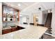 Basement bar with granite countertop, sink, and cabinetry for storage and display at 1104 Fox Ln, Woodstock, GA 30188