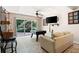 Finished basement area with walkout to the patio, TV, and comfortable seating at 1104 Fox Ln, Woodstock, GA 30188