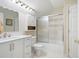 Bright bathroom features tiled shower, modern vanity and cabinet storage at 1104 Fox Ln, Woodstock, GA 30188