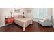 Bedroom featuring natural light, wood floors, a light-blue chair and wood furnishings at 1104 Fox Ln, Woodstock, GA 30188