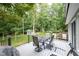 Outdoor deck with dining furniture, overlooking the serene landscaped backyard at 1104 Fox Ln, Woodstock, GA 30188