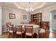 Elegant dining room featuring a tray ceiling, hardwood floors, and a classic hutch, perfect for formal gatherings at 1104 Fox Ln, Woodstock, GA 30188