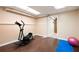 Home exercise area with wood flooring, exercise equipment, and yoga mat at 1104 Fox Ln, Woodstock, GA 30188