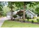 Traditional-style home with lush landscaping, mature trees, and two car garage at 1104 Fox Ln, Woodstock, GA 30188