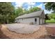 View of this charming home with large paved area, manicured landscaping, and garage at 1104 Fox Ln, Woodstock, GA 30188