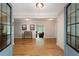 Open foyer showcasing hardwood floors and views into the living spaces, framed by glass double doors for a grand entrance at 1104 Fox Ln, Woodstock, GA 30188