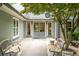 Charming front entrance with double doors, complemented by cozy benches and manicured landscaping, creating a welcoming ambiance at 1104 Fox Ln, Woodstock, GA 30188