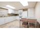 Efficient kitchen with white cabinets and appliances and an eat in dining area at 1104 Fox Ln, Woodstock, GA 30188