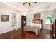Bright main bedroom featuring tray ceiling, hardwood floors and backyard views at 1104 Fox Ln, Woodstock, GA 30188