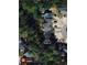 An aerial view showcases the property and neighborhood, surrounded by lush greenery, with houses connected by a driveway at 1139 Shiloh Nw Ln, Kennesaw, GA 30144