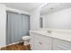 Bathroom featuring a white vanity with storage and a shower with gray shower curtain at 1139 Shiloh Nw Ln, Kennesaw, GA 30144