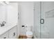 Modern bathroom with glass enclosed shower, vanity, toilet, and built-in storage at 1139 Shiloh Nw Ln, Kennesaw, GA 30144