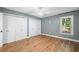 Spacious bedroom with wood-look floors, a ceiling fan, and closet space at 1139 Shiloh Nw Ln, Kennesaw, GA 30144