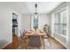 Dining room with wood floors, modern lighting, and adjacent kitchen views at 1139 Shiloh Nw Ln, Kennesaw, GA 30144