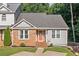 Welcoming home exterior showcasing an inviting front door with decorative glass, brick detail and landscaping at 1139 Shiloh Nw Ln, Kennesaw, GA 30144
