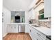 Bright kitchen boasting stainless steel appliances, white cabinetry, and a view to the living area at 1139 Shiloh Nw Ln, Kennesaw, GA 30144