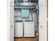 A well lit laundry room offering new front load washer and dryer and storage cabinet at 1139 Shiloh Nw Ln, Kennesaw, GA 30144