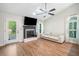 Cozy living room with hardwood floors, fireplace, and abundant natural light at 1139 Shiloh Nw Ln, Kennesaw, GA 30144