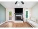 Cozy living room with hardwood floors, fireplace, and abundant natural light at 1139 Shiloh Nw Ln, Kennesaw, GA 30144