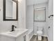 This bathroom features modern finishes with a white vanity and black fixtures at 2899 Gresham Se Rd, Atlanta, GA 30316