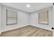 Spacious bedroom with gray walls, gray flooring, and two large windows at 2899 Gresham Se Rd, Atlanta, GA 30316