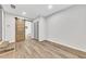This bedroom features wood-look flooring and a sliding barn door to the en suite bathroom at 2899 Gresham Se Rd, Atlanta, GA 30316