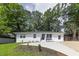 Charming exterior view of a newly renovated single-story home with a well-manicured lawn and a private driveway at 2899 Gresham Se Rd, Atlanta, GA 30316