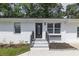A close up of the exterior front entrance to a renovated home with modern accents at 2899 Gresham Se Rd, Atlanta, GA 30316