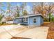 Side view of blue ranch-style home with spacious driveway and minimal landscaping at 2899 Gresham Se Rd, Atlanta, GA 30316