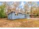 Blue ranch-style home side view featuring updated landscaping and fresh exterior paint at 2899 Gresham Se Rd, Atlanta, GA 30316