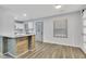 Open-concept kitchen featuring a breakfast bar, white cabinetry, and hardwood floors at 2899 Gresham Se Rd, Atlanta, GA 30316