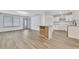 Open-concept living space featuring new gray flooring, a kitchen island, and lots of natural light at 2899 Gresham Se Rd, Atlanta, GA 30316